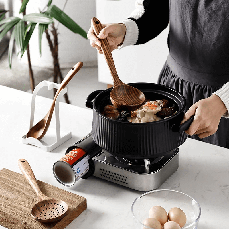 Living Mozaic teak wood cooking utensils in ceramic holder on kitchen benchtop